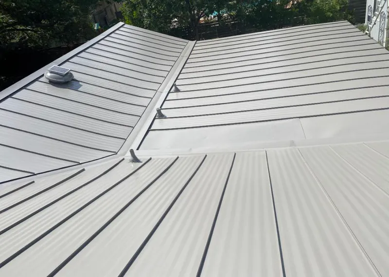 Solar attic fan installed on a metal roof for Roof Ventilation in La Follette